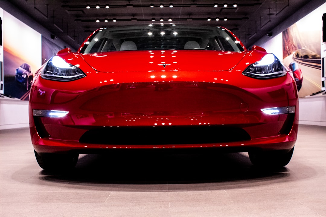 NHTSA logo and Tesla Model 3/Y car on road